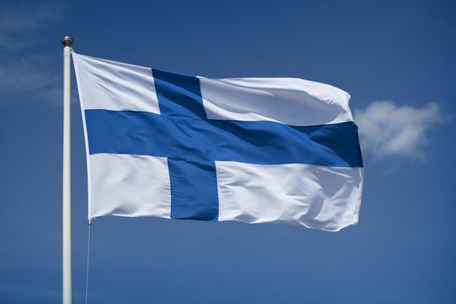 דגל פיני מונף עם רקע שמיים כחולים